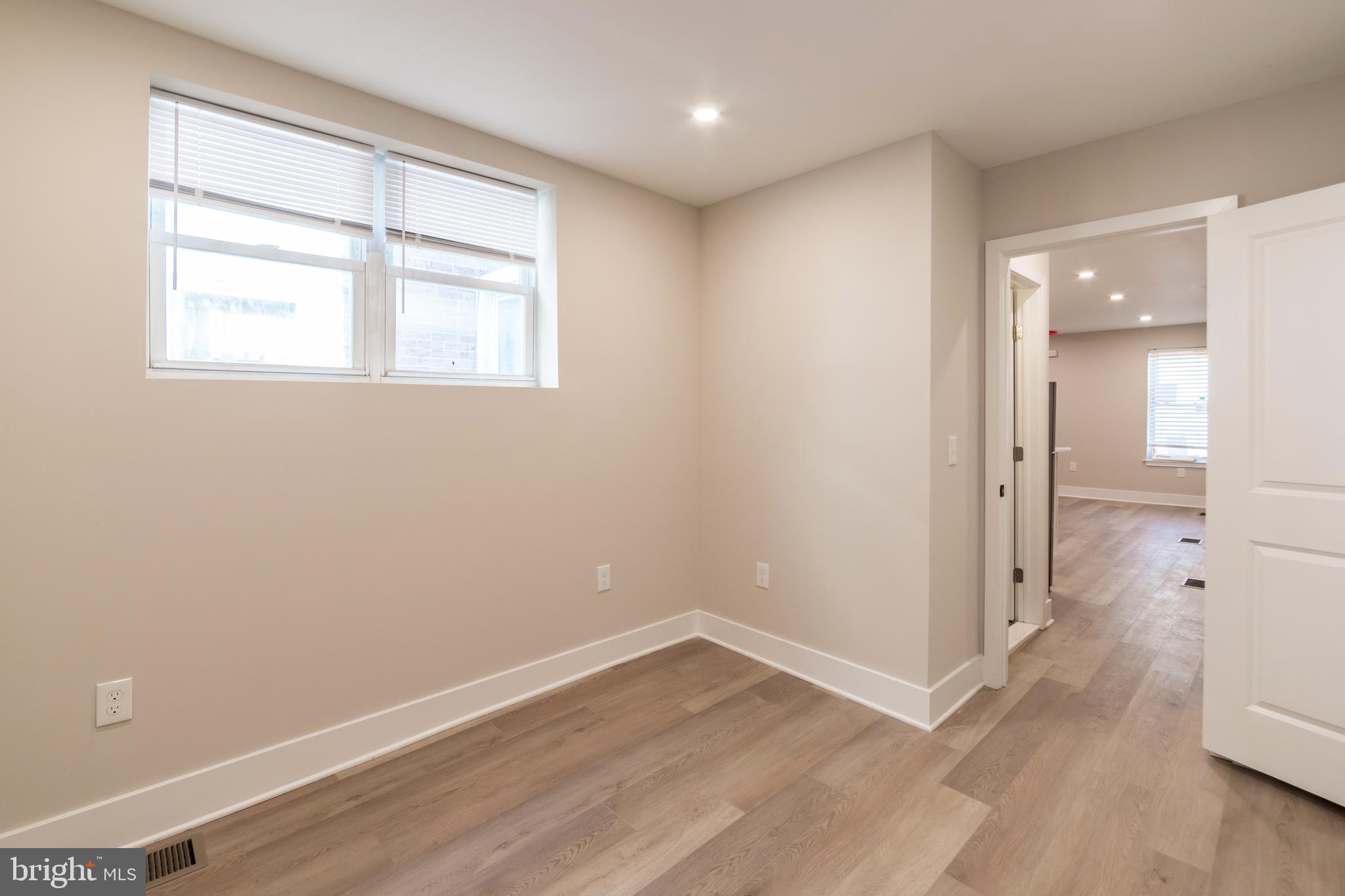 1844 South 23rd Street, Unit 1F Philadelphia, PA 19145 - Photo 11 of 21 an empty room with wooden floor and windows