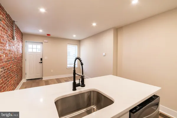 a view of a kitchen with a sink and refrigerator