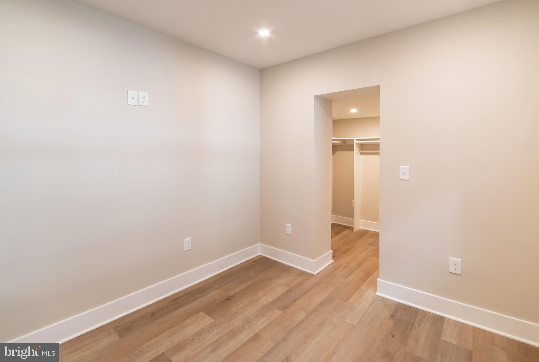 1844 South 23rd Street, Unit 1F Philadelphia, PA 19145 - Photo 9 of 21 a view of an empty room with wooden floor and closet