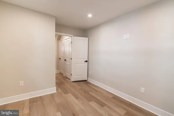 an empty room with wooden floor and window