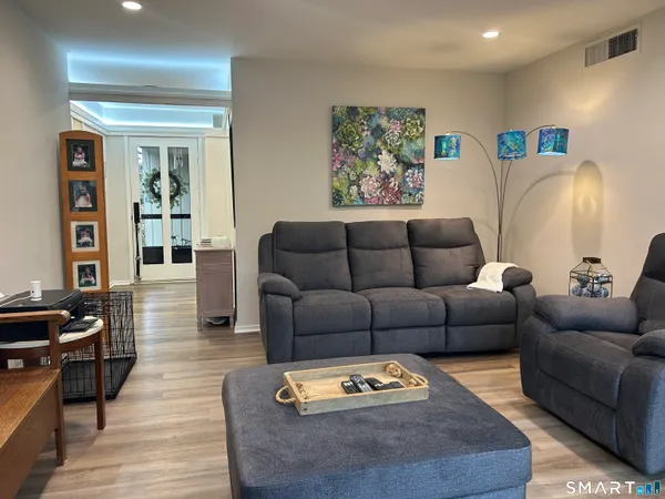 a living room with furniture and wooden floor