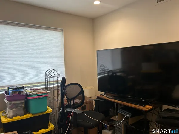 a room with furniture and a flat screen tv