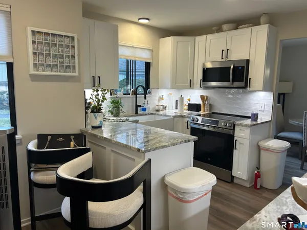 a kitchen with a sink stove and microwave