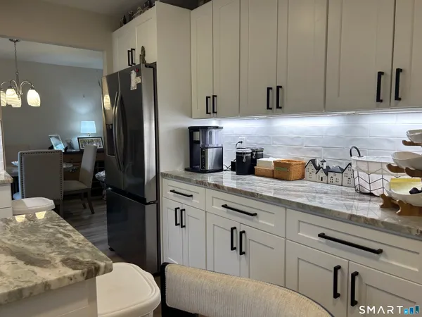 a kitchen with stainless steel appliances a refrigerator sink and cabinets