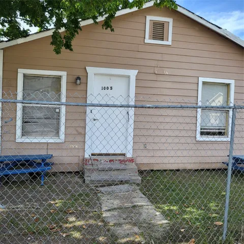 a view of brick house with a large window