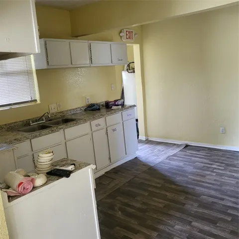 a kitchen with granite countertop a sink and a stove