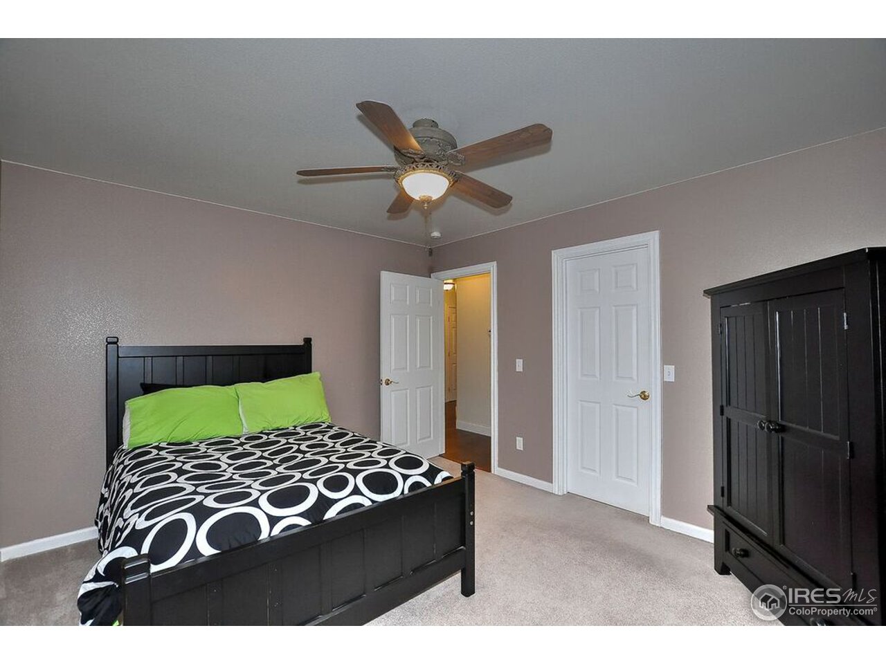 126 52nd Avenue Greeley, CO 80634 - Photo 14 of 24 a bed room with a bed and a television