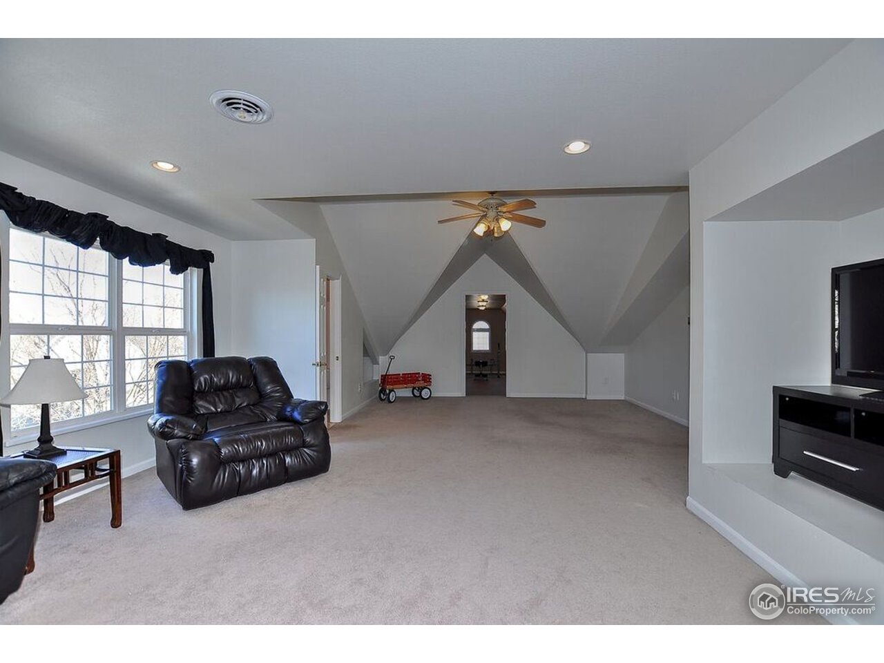 126 52nd Avenue Greeley, CO 80634 - Photo 17 of 24 a living room with furniture and a flat screen tv