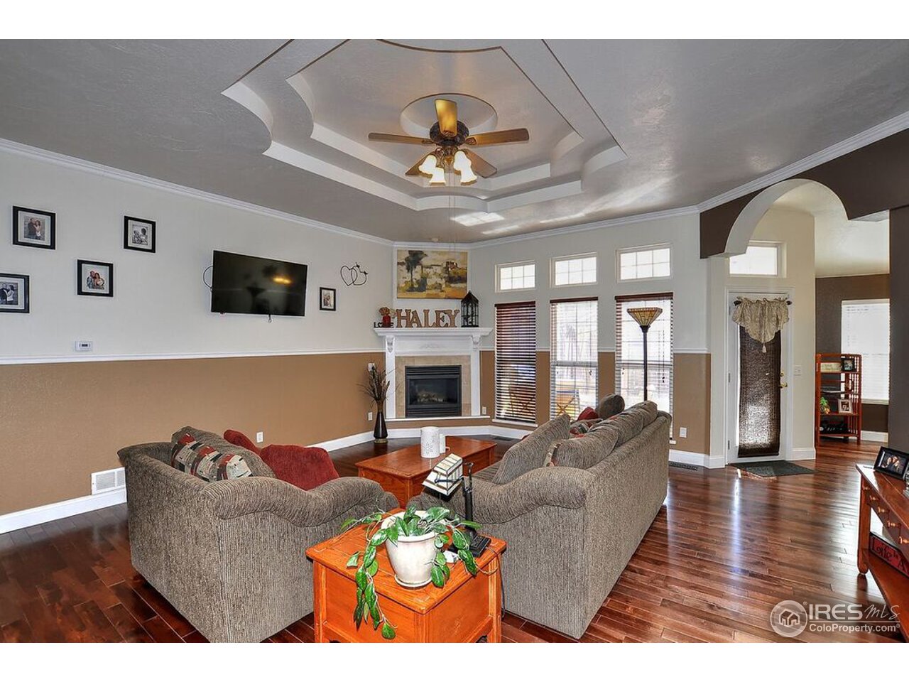 126 52nd Avenue Greeley, CO 80634 - Photo 5 of 24 a living room with furniture a fireplace and a flat screen tv