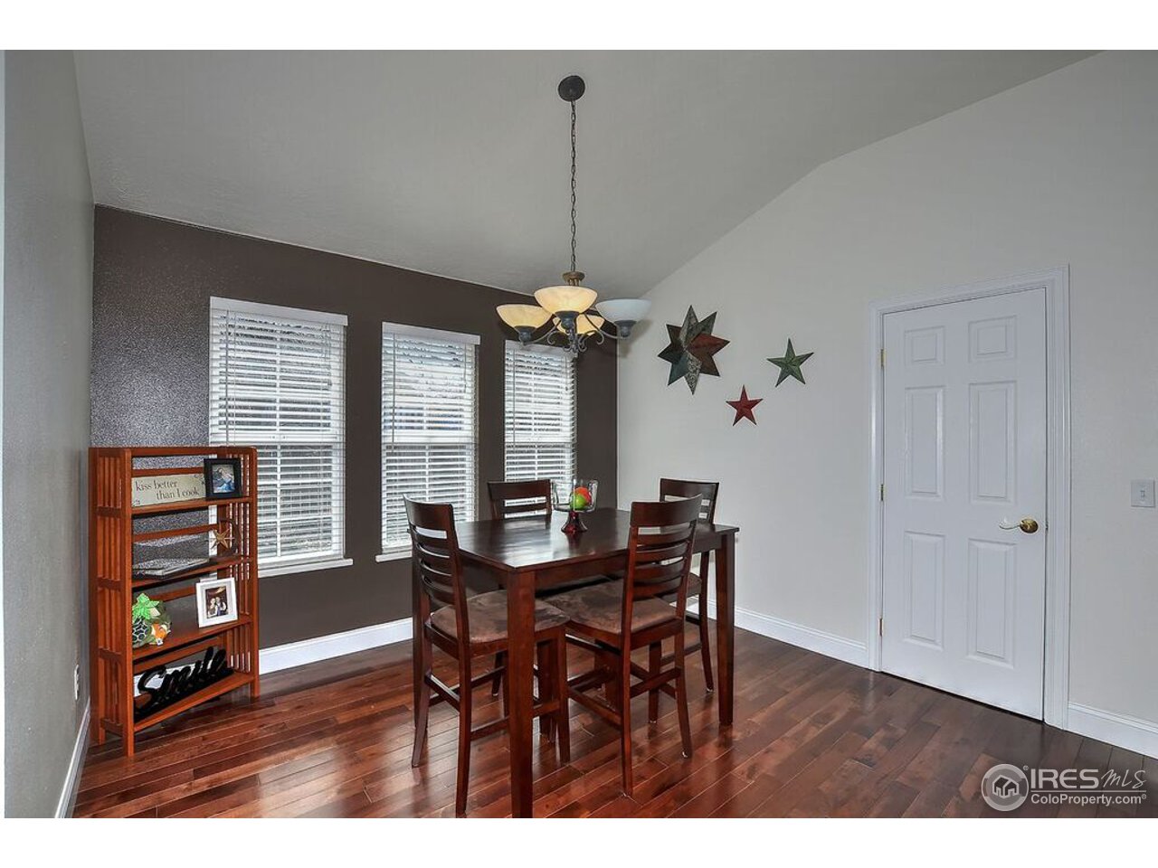 126 52nd Avenue Greeley, CO 80634 - Photo 9 of 24 a view of a dining room with furniture window and wooden floor