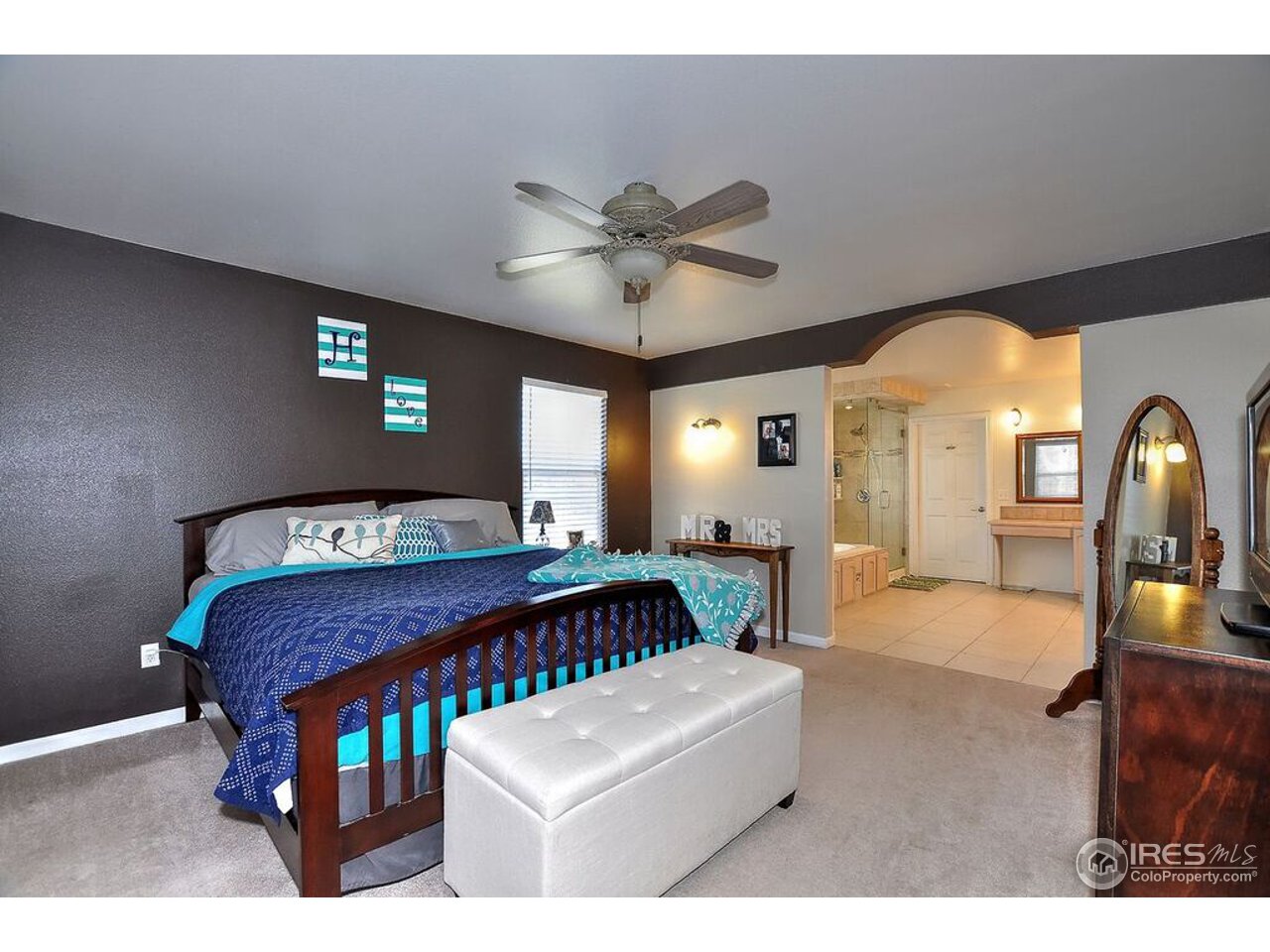 126 52nd Avenue Greeley, CO 80634 - Photo 10 of 24 a bedroom with furniture and a chandelier