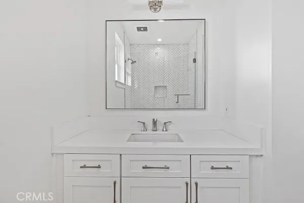 a bathroom with a sink vanity and mirror