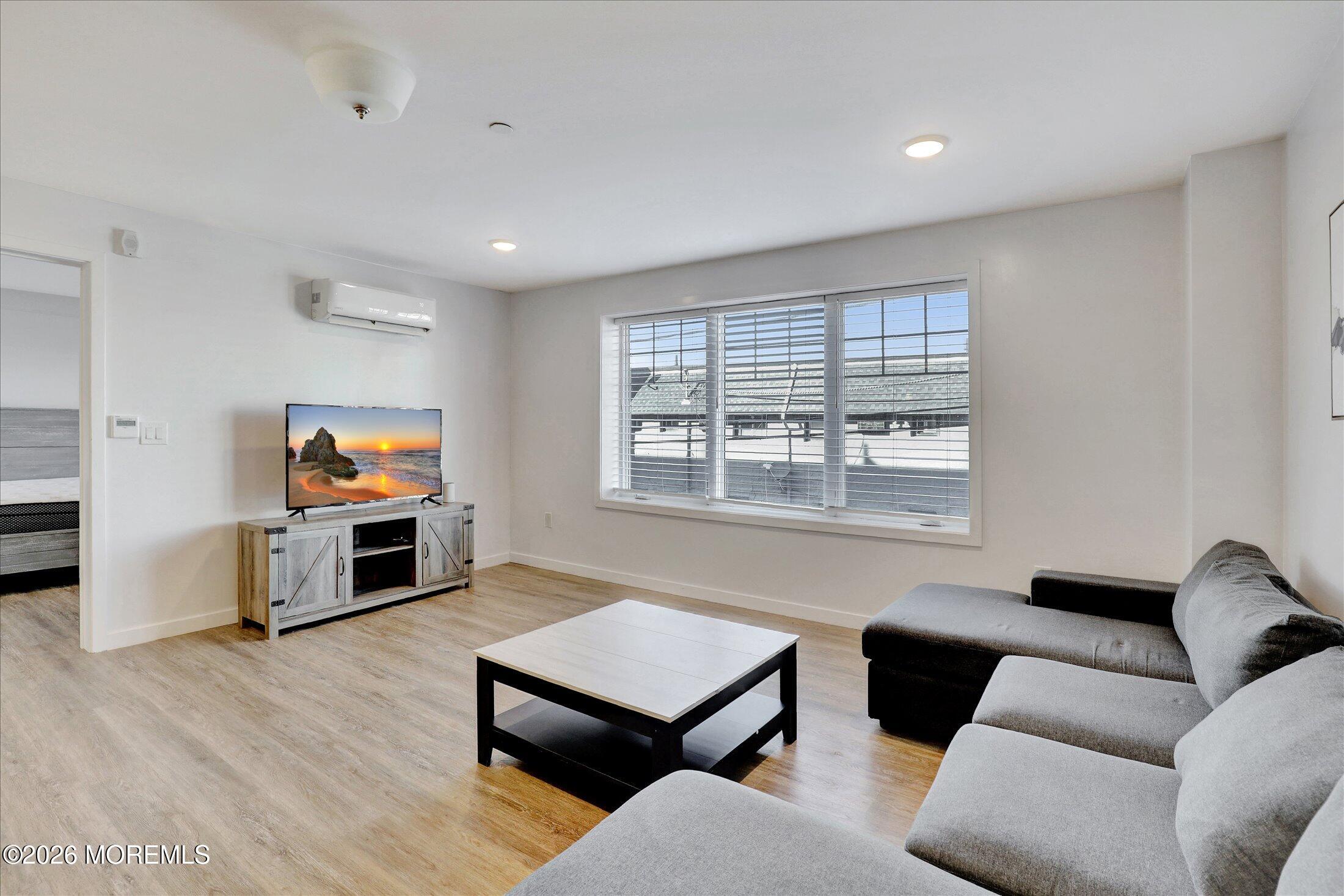 55 Brighton Avenue, Unit 4 Long Branch, NJ 07740 - Photo 17 of 36 a living room with furniture and a flat screen tv