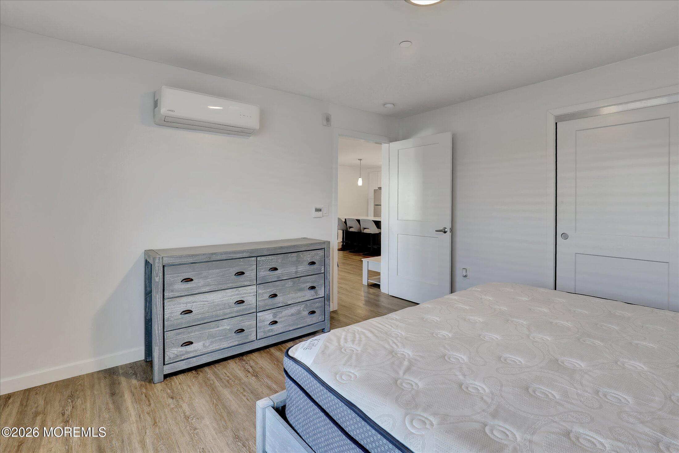 55 Brighton Avenue, Unit 4 Long Branch, NJ 07740 - Photo 22 of 36 a bedroom with a bed and a dresser