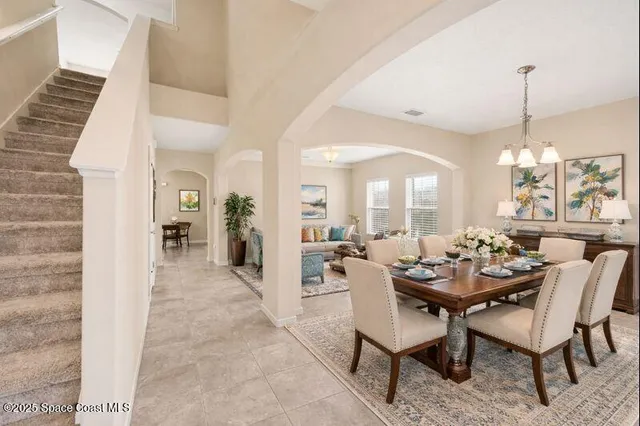 an empty room with closet and a chandelier fan