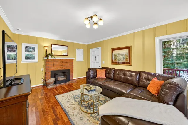 a living room with furniture fireplace and a flat screen tv