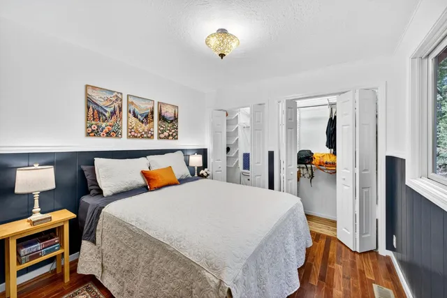 a bedroom with a bed and a lamp