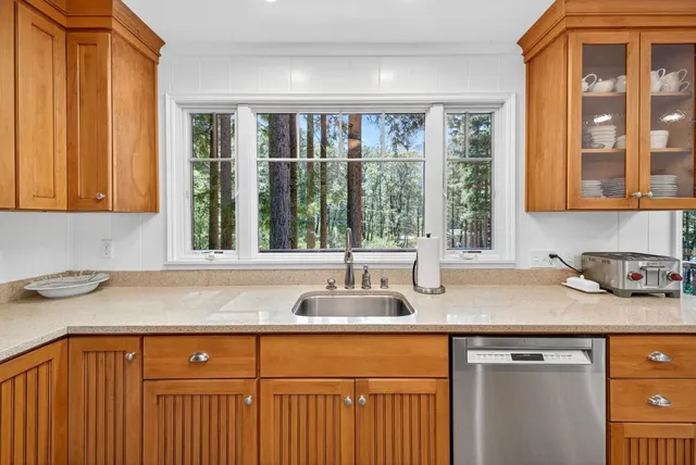 a kitchen with granite countertop a sink and a window