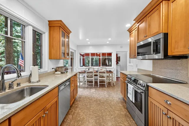 a kitchen with stainless steel appliances granite countertop a sink and a stove