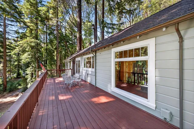 a view of backyard with a deck and wooden floor