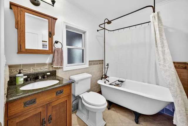 a bathroom with a sink toilet a mirror and shower