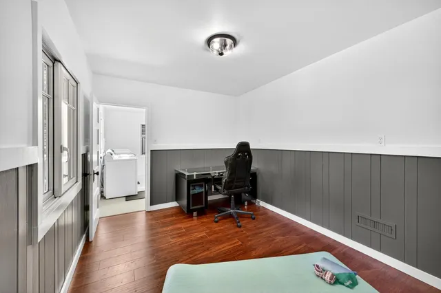 a view of a workspace with furniture and a gate