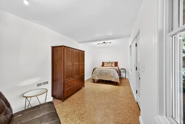 a bedroom with a bed and chair