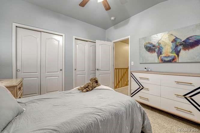 12365 Point Reyes Drive Peyton, CO 80831 - Photo 17 of 44 a bedroom with a bed and a chandelier