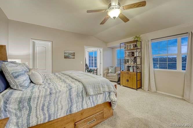 12365 Point Reyes Drive Peyton, CO 80831 - Photo 20 of 44 a bedroom with a large bed and a chandelier