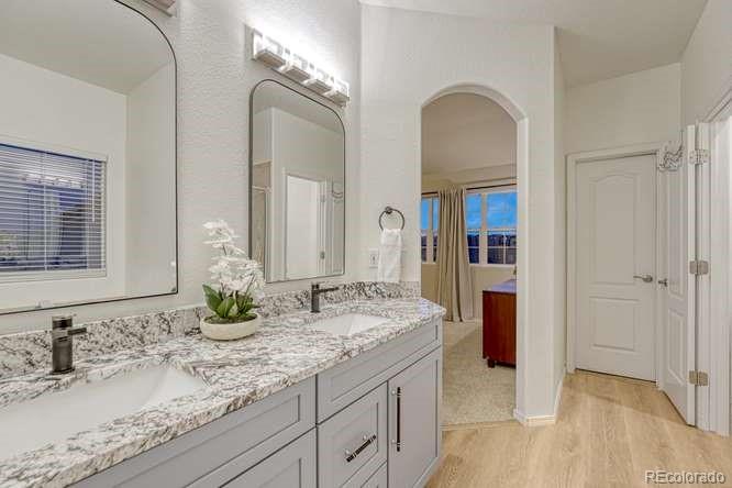 12365 Point Reyes Drive Peyton, CO 80831 - Photo 23 of 44 a bathroom with a granite countertop sink and a mirror