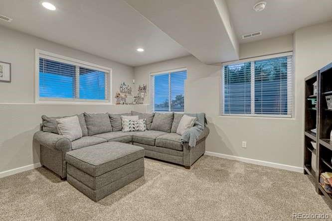 12365 Point Reyes Drive Peyton, CO 80831 - Photo 27 of 44 a living room with furniture and a flat screen tv