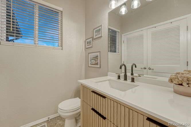 12365 Point Reyes Drive Peyton, CO 80831 - Photo 29 of 44 a bathroom with a sink a toilet and mirror