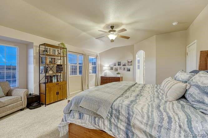 12365 Point Reyes Drive Peyton, CO 80831 - Photo 5 of 44 a spacious bedroom with a bed and ceiling fan