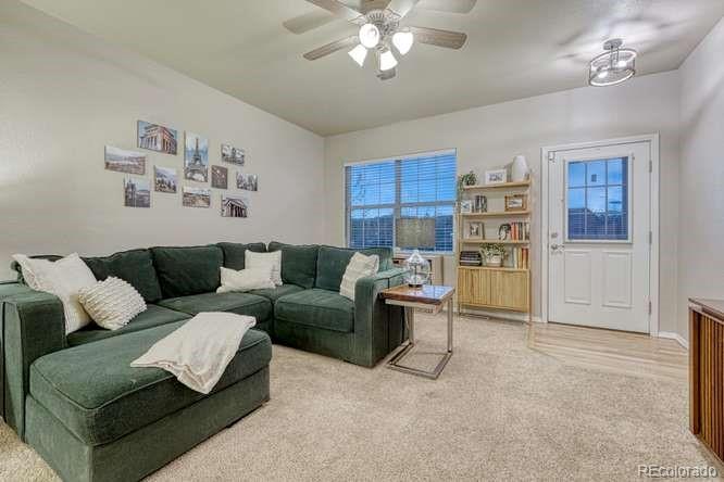 12365 Point Reyes Drive Peyton, CO 80831 - Photo 6 of 44 a living room with furniture and a chandelier