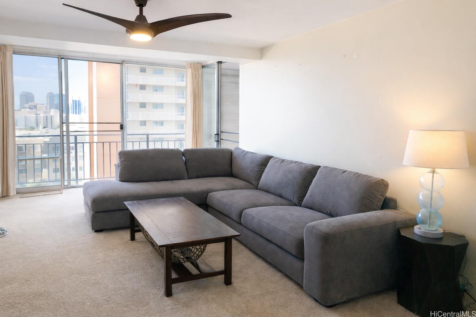 1415 Victoria Street, Unit 906 Honolulu, HI 96822 - Photo 7 of 16 a living room with furniture and a window