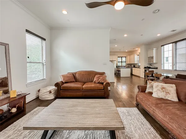 a living room with furniture ceiling fan and a rug
