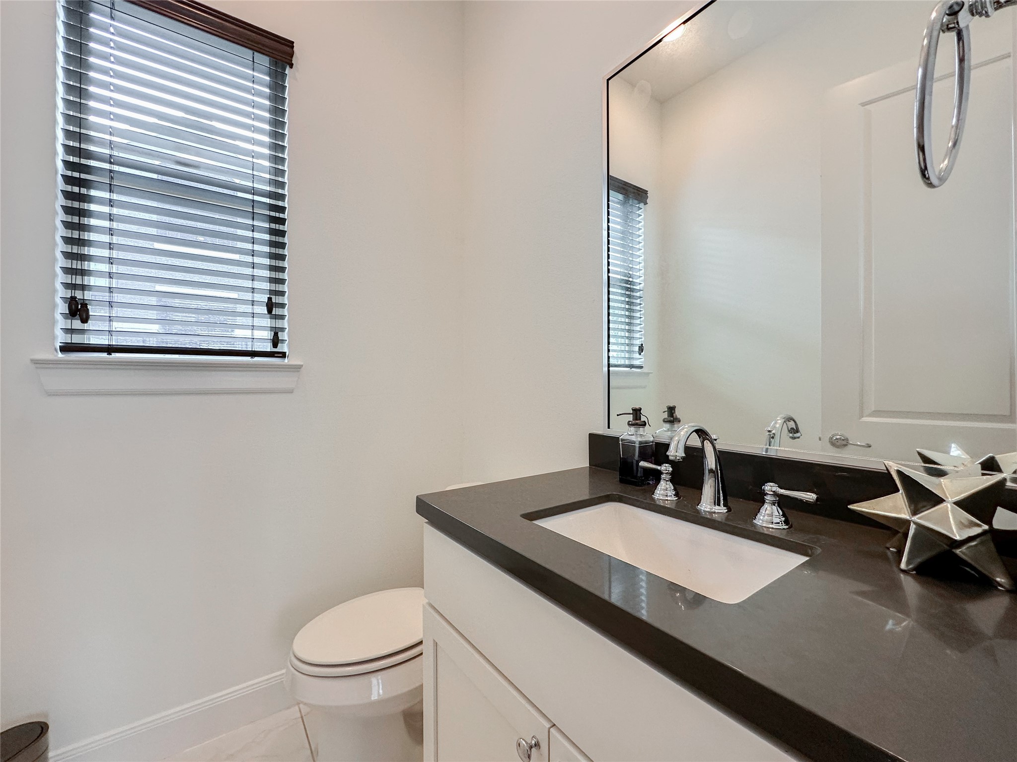 2 Hermann Park Court Houston, TX 77021 - Photo 20 of 43 a bathroom with a granite countertop sink and a toilet
