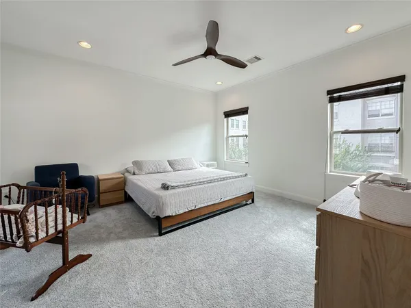 a spacious bedroom with a bed and window