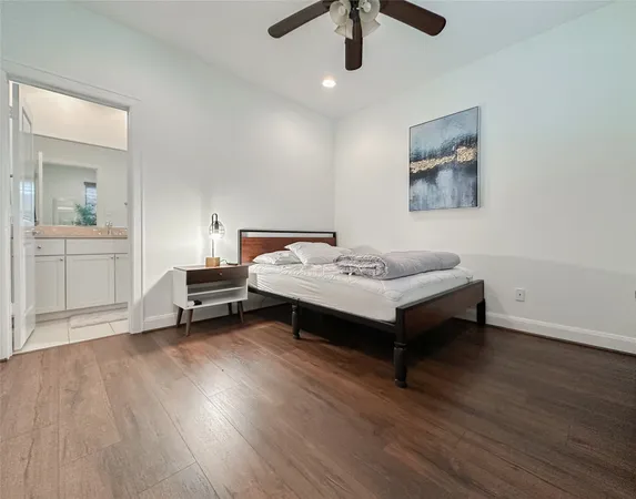a bedroom with a bed and a ceiling fan