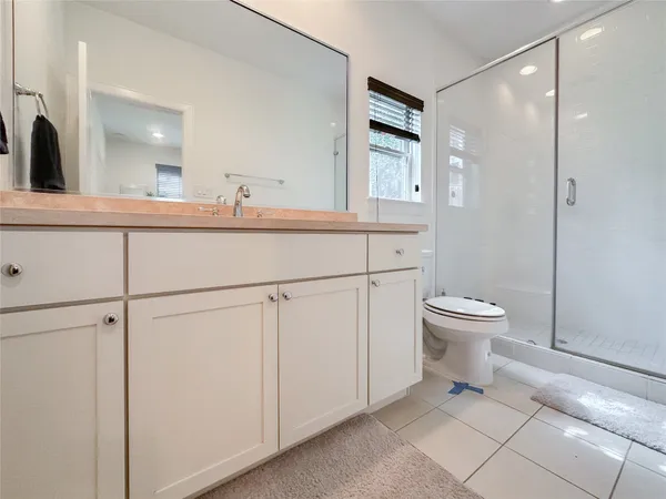 a bathroom with a sink a toilet and mirror