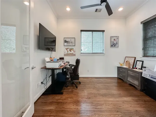 a view of a workspace with furniture and a window