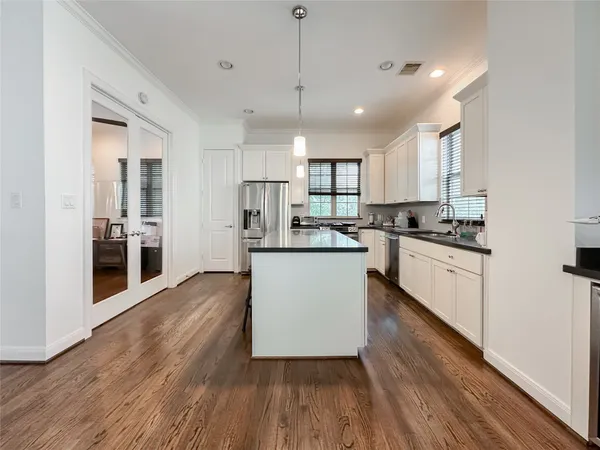 a view of kitchen with sink and wooden floor