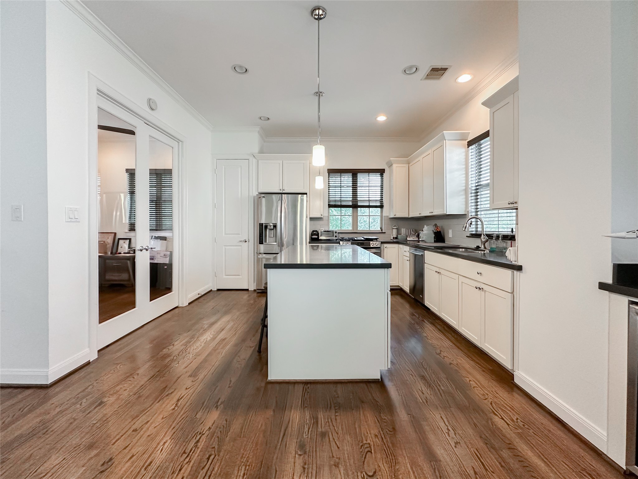 2 Hermann Park Court Houston, TX 77021 - Photo 9 of 43 a kitchen with kitchen island white cabinets and stainless steel appliances