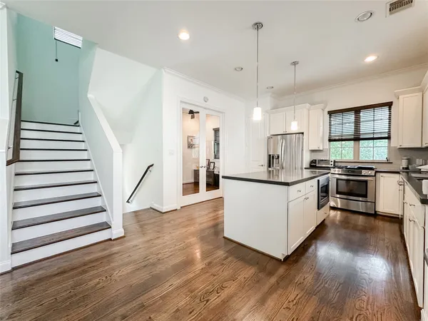 a living room with furniture dining table and wooden floor