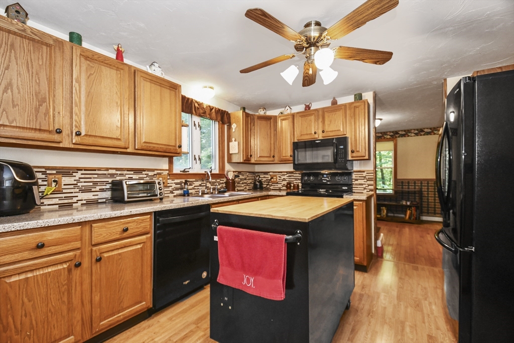 549 Chestnut Hill Road Millville, MA 01529 - Photo 11 of 38 a kitchen with stainless steel appliances granite countertop a refrigerator a stove top oven a sink and dishwasher