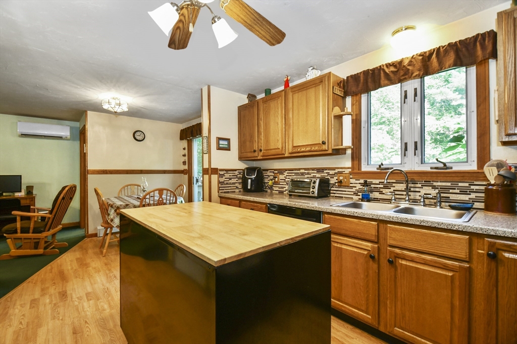 549 Chestnut Hill Road Millville, MA 01529 - Photo 13 of 38 a kitchen with wooden cabinets a sink a stove and a refrigerator