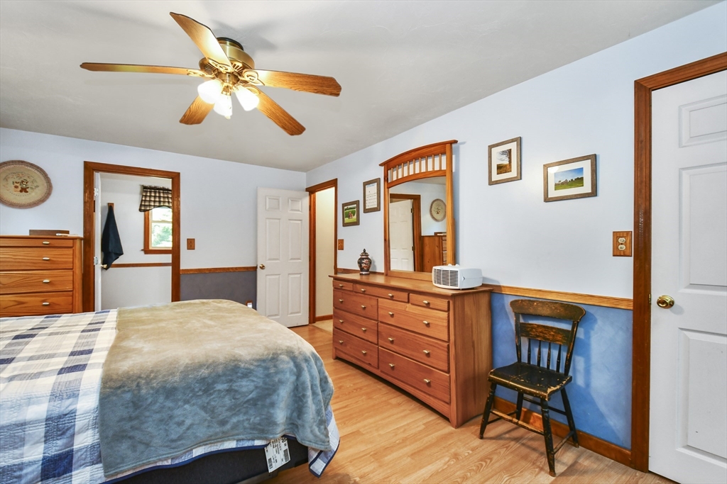 549 Chestnut Hill Road Millville, MA 01529 - Photo 17 of 38 a bedroom with a bed and wooden floor