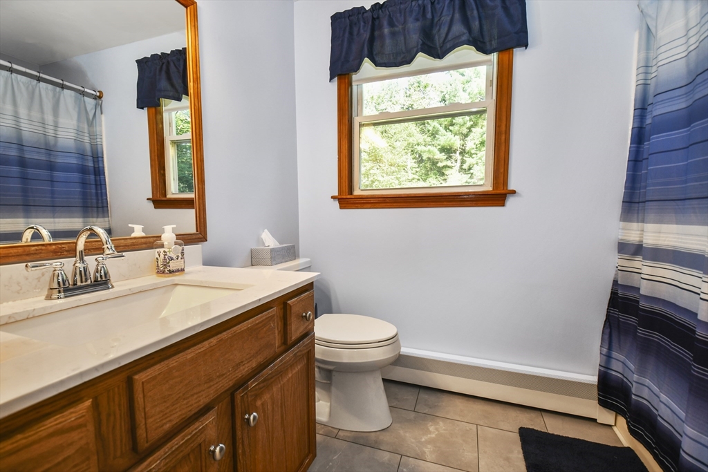 549 Chestnut Hill Road Millville, MA 01529 - Photo 18 of 38 a bathroom with a sink a toilet and a mirror