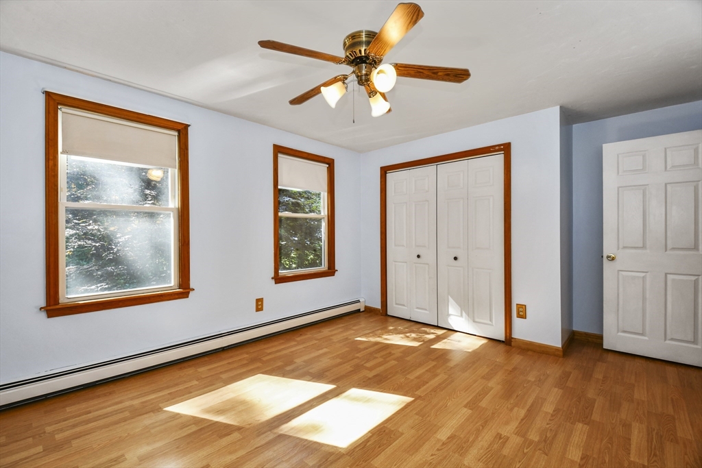 549 Chestnut Hill Road Millville, MA 01529 - Photo 20 of 38 a view of an empty room with window and wooden floor