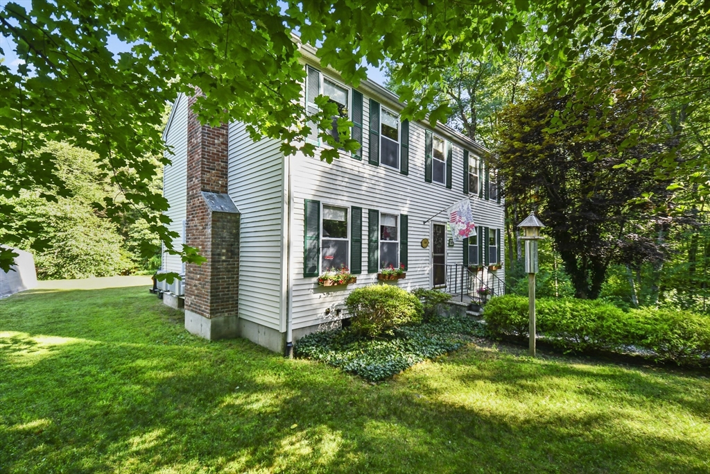 549 Chestnut Hill Road Millville, MA 01529 - Photo 2 of 38 a view of a house with a yard and sitting area